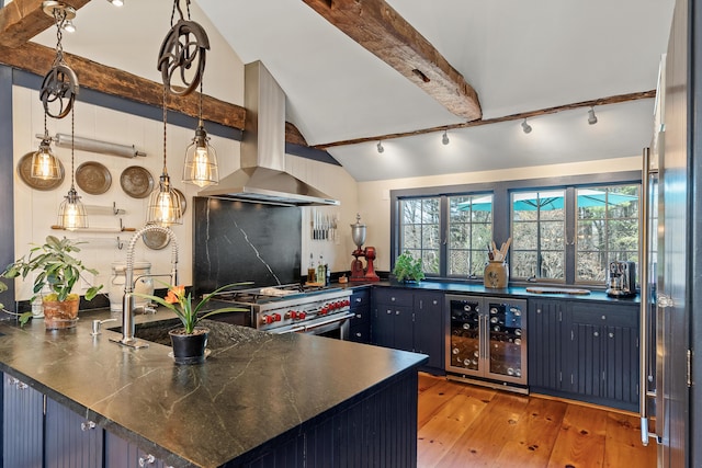 875 N Parish Rd, Turner, ME 04282 - kitchen with dark countertops, lofted ceiling with beams, extractor fan, range with two ovens, and wine cooler