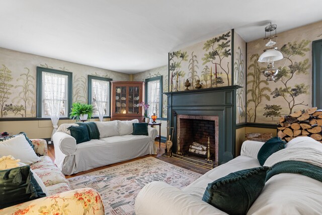875 N Parish Rd, Turner, ME 04282 - living area with a fireplace, wallpapered walls, and wood finished floors