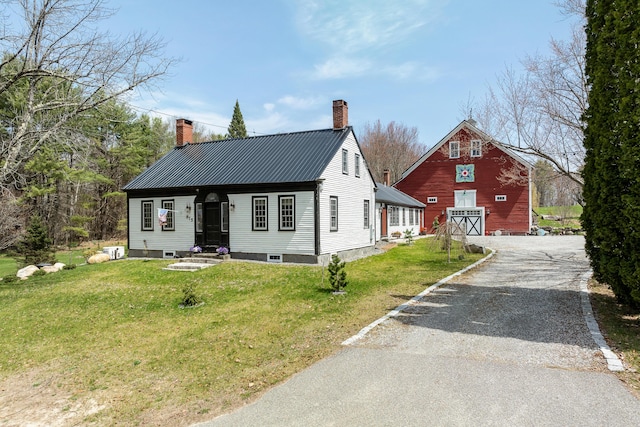875 N Parish Rd, Turner, ME 04282 - view of front of property featuring a front lawn, aphalt driveway, a chimney, a barn, and an outbuilding