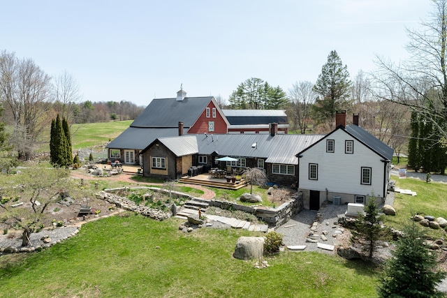 875 N Parish Rd, Turner, ME 04282 - rear view of house featuring a yard, a deck, and metal roof