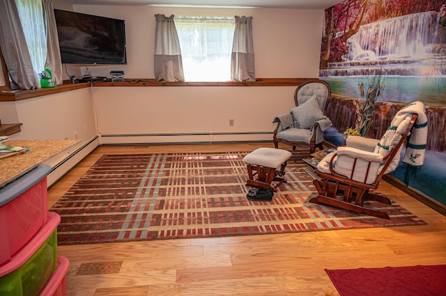 sitting room featuring wood finished floors and baseboard heating