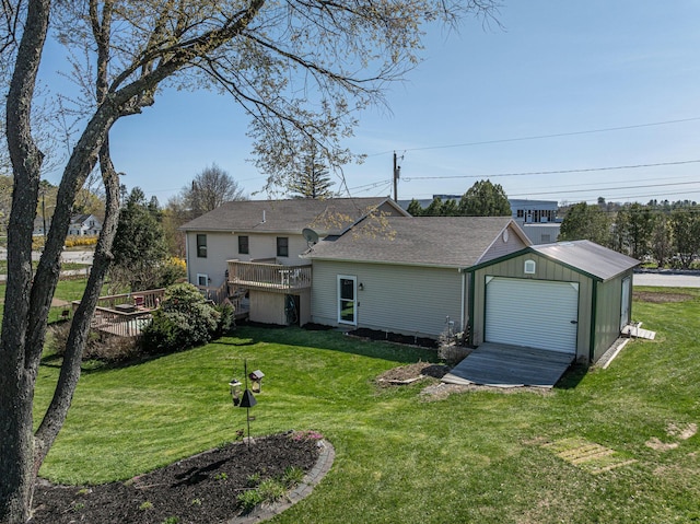 rear view of house featuring a wooden deck, an outdoor structure, and a lawn