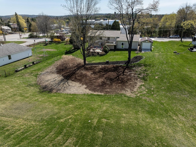 view of yard with fence and a garage
