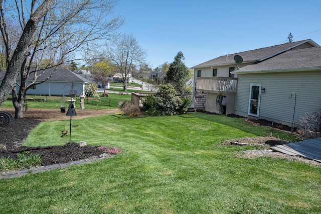 view of grassy yard featuring a wooden deck