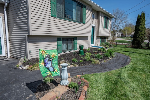view of property exterior featuring a lawn