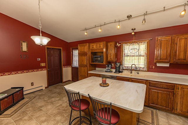 kitchen featuring a sink, built in microwave, a baseboard radiator, light countertops, and lofted ceiling
