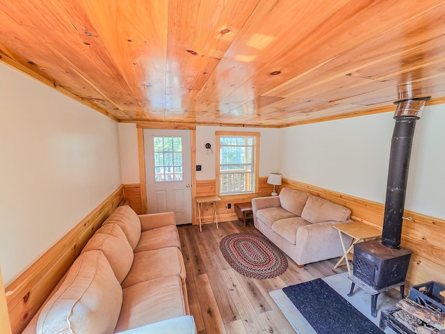 living room featuring wooden ceiling, a wainscoted wall, wooden walls, and hardwood / wood-style floors