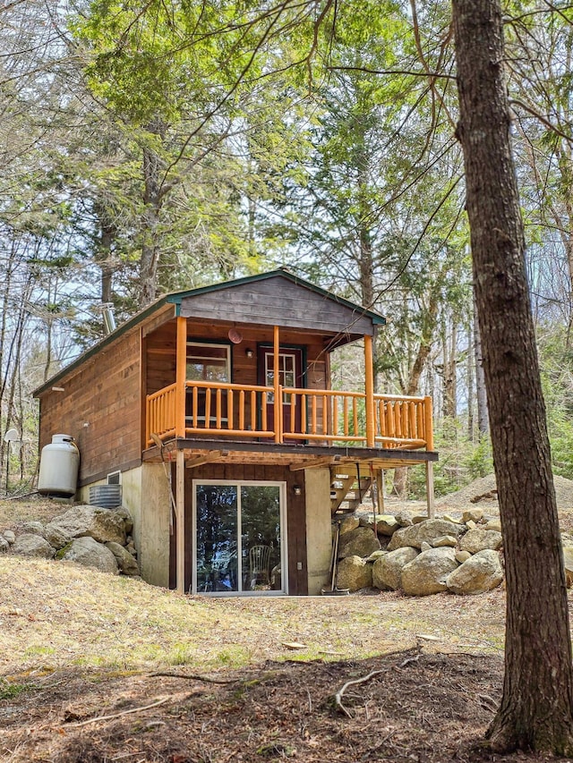 back of property featuring a wooden deck