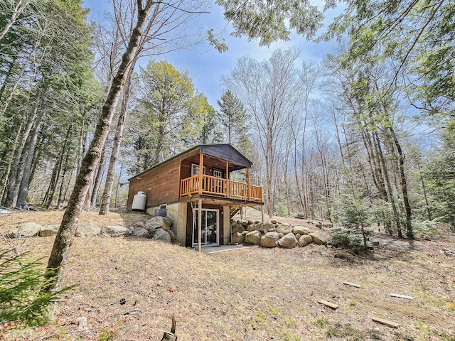 rear view of house featuring a deck