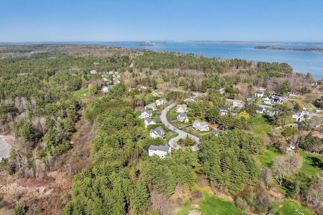 aerial view with a residential view, a view of trees, and a water view