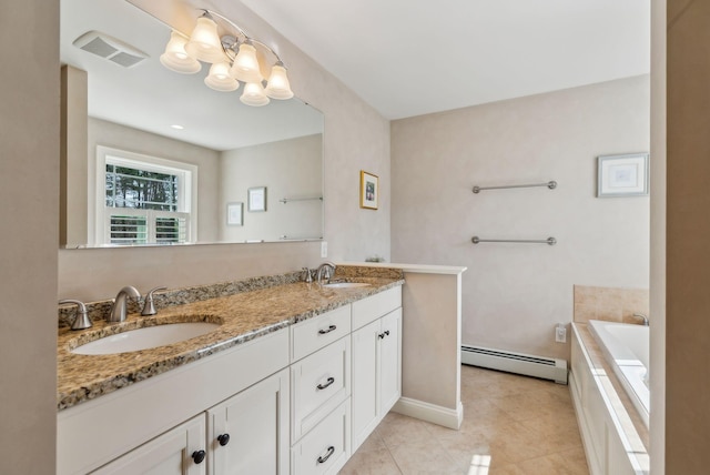 full bath with tile patterned flooring, double vanity, baseboard heating, a relaxing tiled tub, and a sink