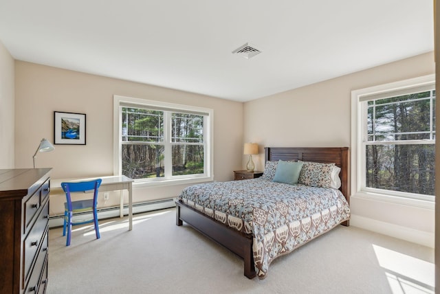 bedroom with visible vents, carpet, and a baseboard heating unit