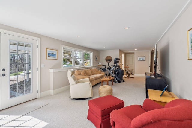 living area with baseboards, recessed lighting, and carpet