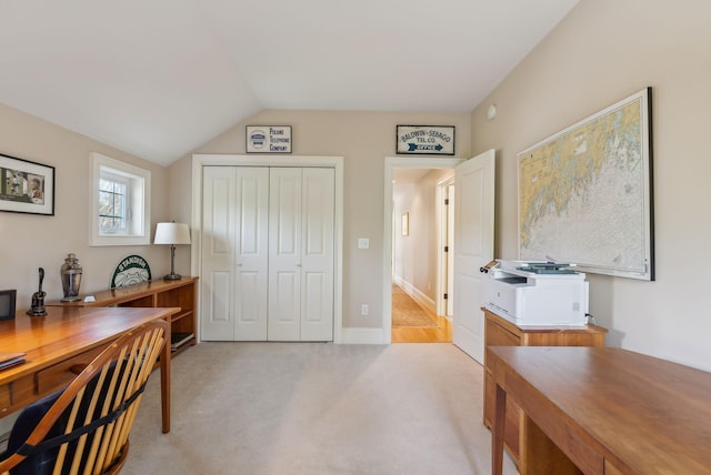 office area with lofted ceiling and light colored carpet