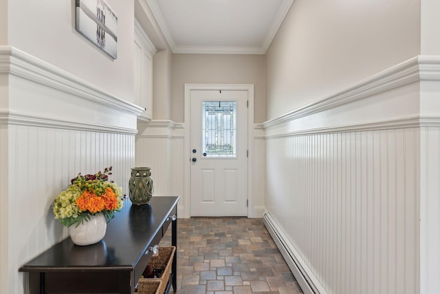 entryway featuring ornamental molding, wainscoting, a baseboard heating unit, and stone finish floor