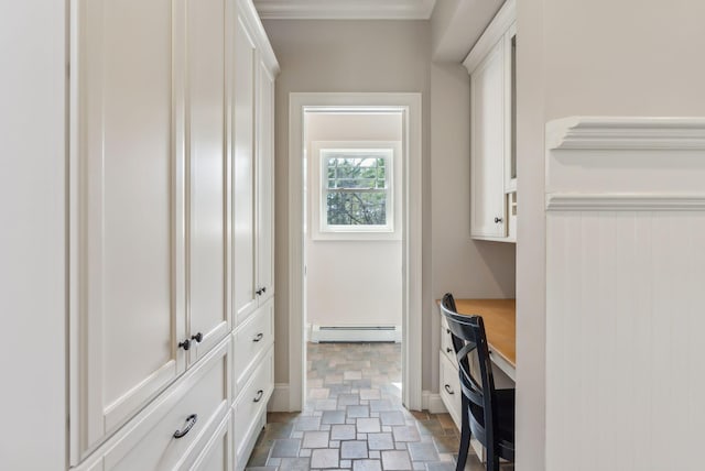 interior space with stone finish flooring, baseboards, and a baseboard heating unit