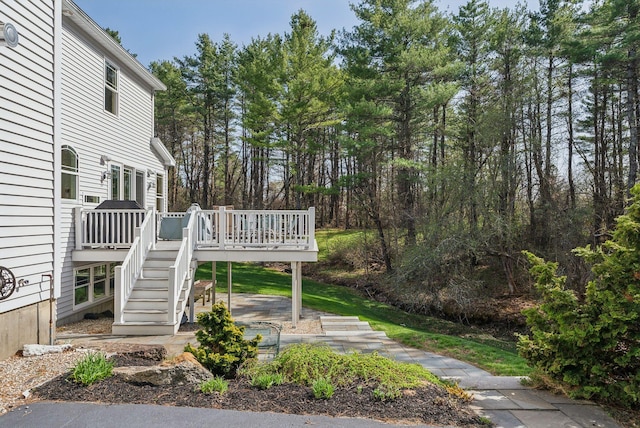 view of yard with stairs and a wooden deck