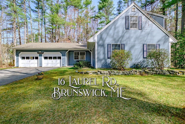 view of front of house featuring a garage, a chimney, a front lawn, and aphalt driveway