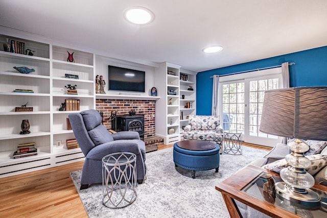 living area featuring a wood stove and wood finished floors