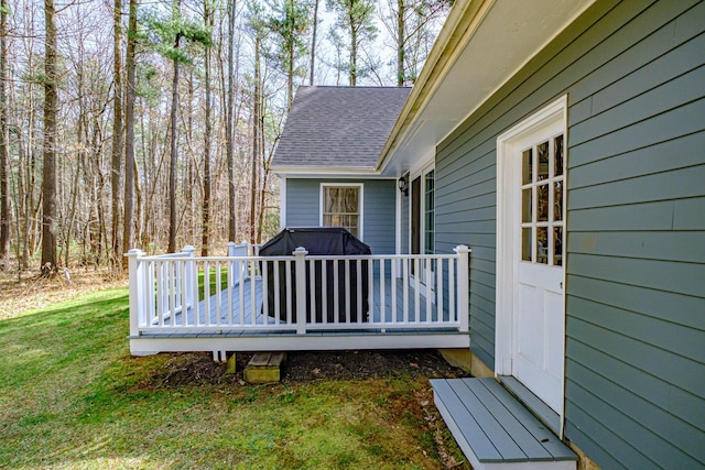 wooden terrace featuring a lawn