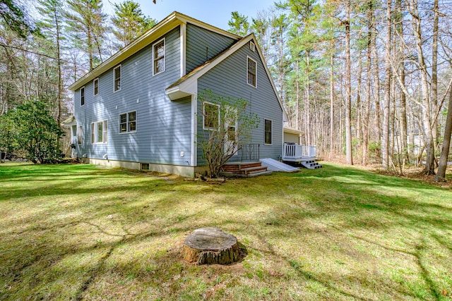 back of house with a lawn and a wooden deck