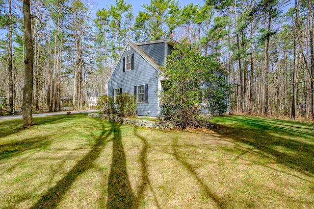 view of property exterior featuring a lawn
