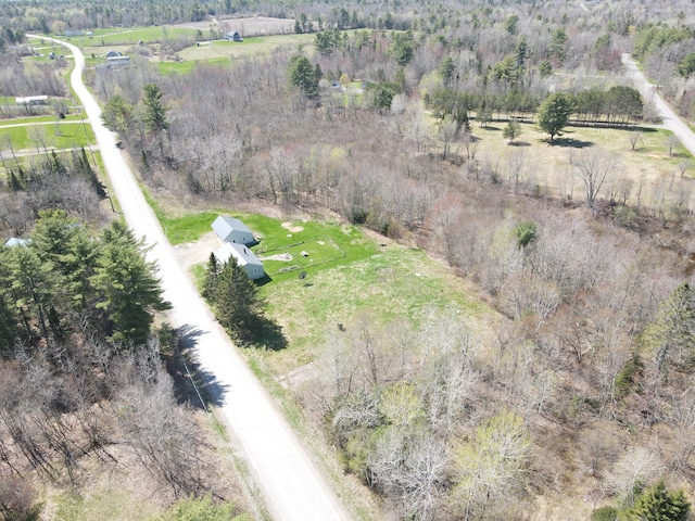 birds eye view of property featuring a rural view and a wooded view