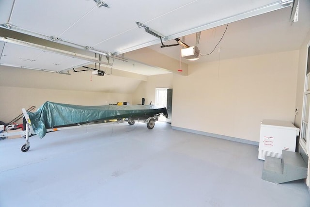 garage with baseboards and a garage door opener