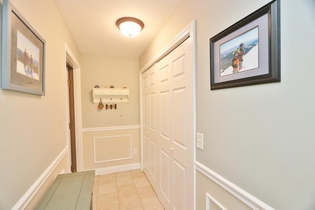 doorway to outside with light tile patterned floors