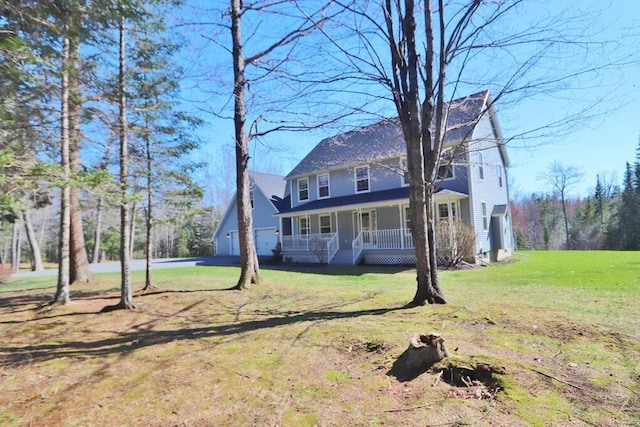 colonial home featuring a porch and a front yard