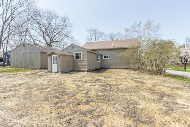 back of property with an outbuilding and a storage unit