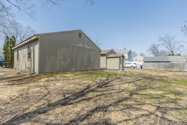 view of shed featuring fence