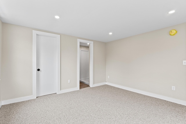 unfurnished bedroom with recessed lighting, carpet flooring, baseboards, and a closet