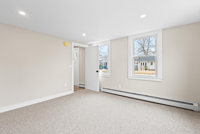 carpeted empty room featuring recessed lighting and baseboard heating