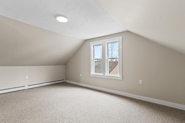bonus room with carpet, baseboard heating, and vaulted ceiling