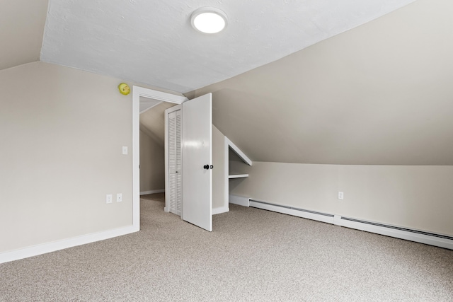 bonus room with baseboards, carpet flooring, a baseboard heating unit, and vaulted ceiling