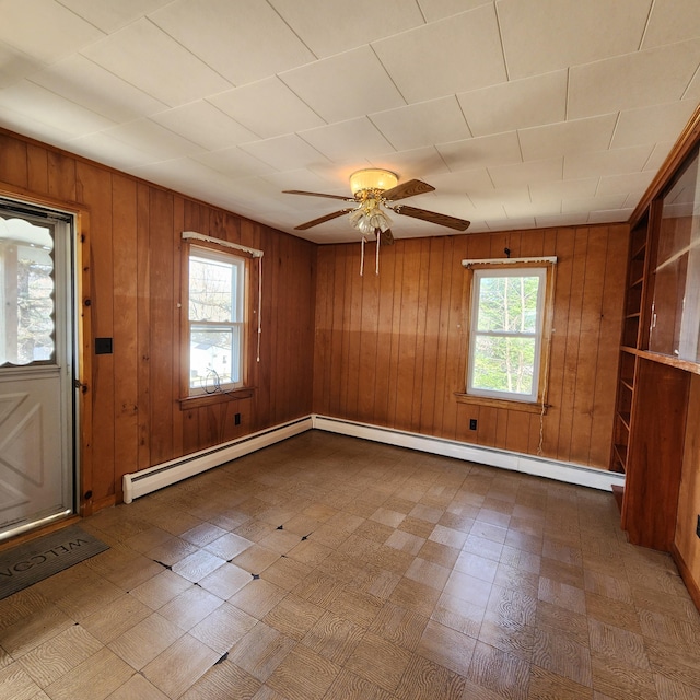 34 Chase Ave, Mexico, ME 04257 - foyer featuring tile patterned floors, wooden walls, ceiling fan, and a baseboard heating unit
