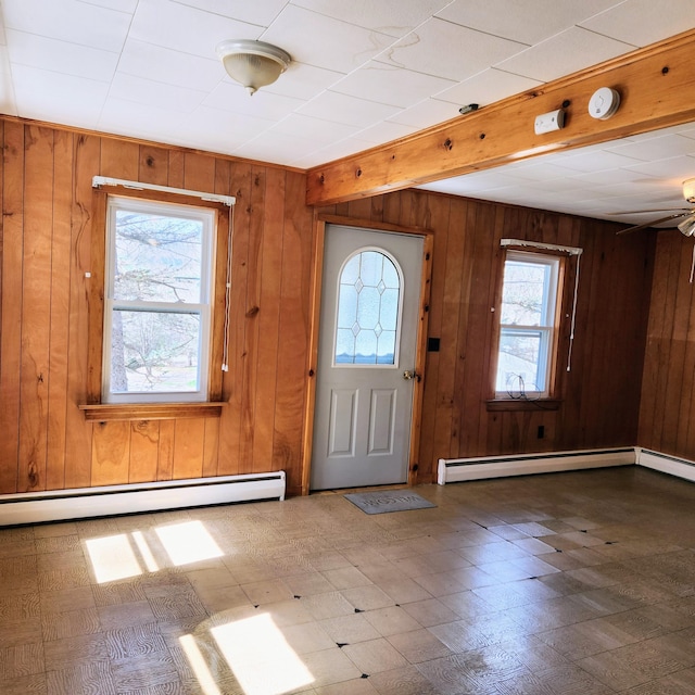 34 Chase Ave, Mexico, ME 04257 - foyer with tile patterned floors, wooden walls, a baseboard radiator, a ceiling fan, and beamed ceiling