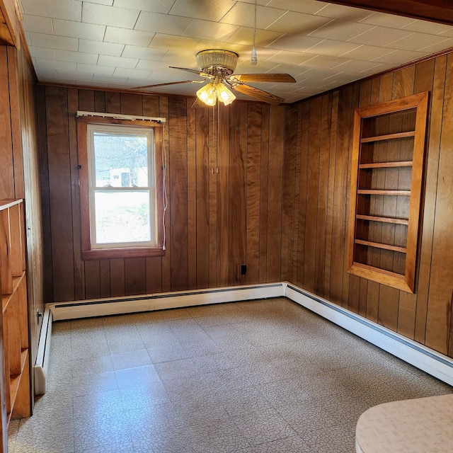 34 Chase Ave, Mexico, ME 04257 - spare room with built in features, wood walls, a ceiling fan, tile patterned floors, and a baseboard radiator