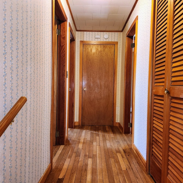34 Chase Ave, Mexico, ME 04257 - corridor with wallpapered walls, hardwood / wood-style floors, and baseboards