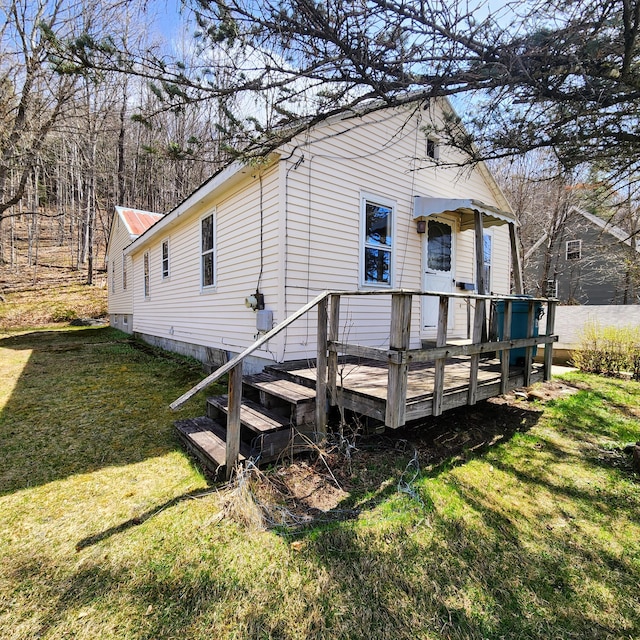 34 Chase Ave, Mexico, ME 04257 - rear view of house with a lawn, a deck, and metal roof