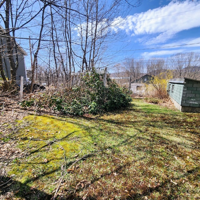 34 Chase Ave, Mexico, ME 04257 - view of grassy yard featuring an outbuilding and a shed