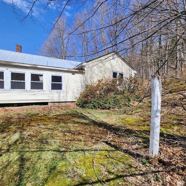 34 Chase Ave, Mexico, ME 04257 - view of property exterior featuring a chimney