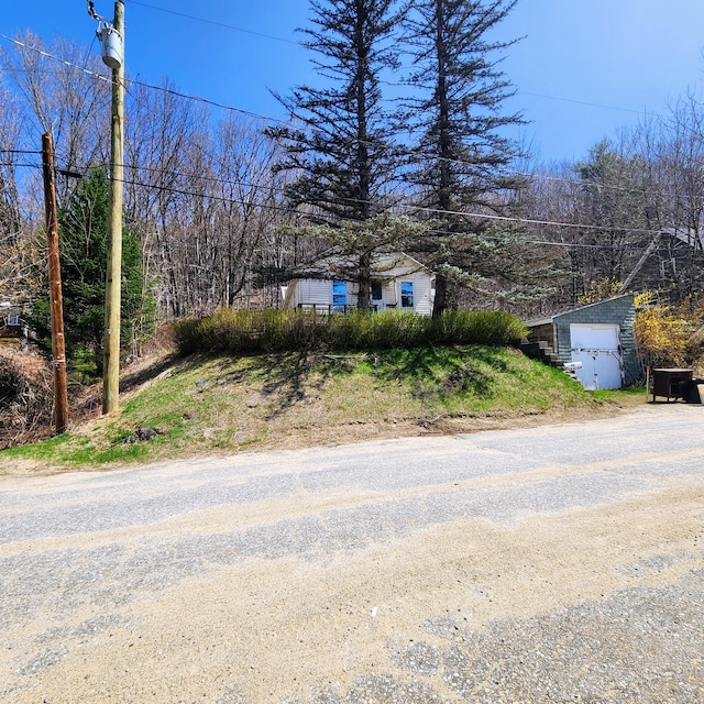 34 Chase Ave, Mexico, ME 04257 - view of front facade featuring an outdoor structure, a shed, and driveway