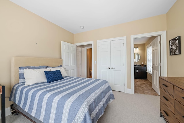 75 Clearwater Dr Unit 305, Falmouth, ME 04105 - bedroom with baseboards, light carpet, and a closet