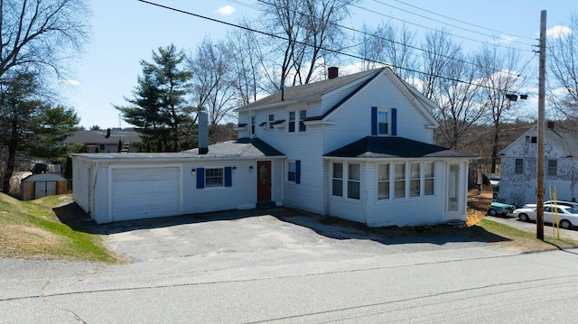 traditional-style house with a chimney and a garage