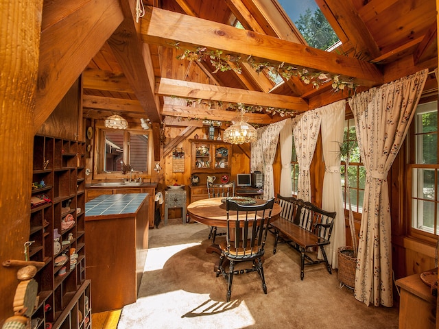 carpeted dining room with wood ceiling, beam ceiling, and a chandelier