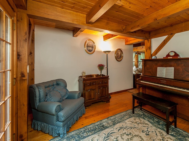 sitting room featuring wood ceiling, baseboards, beam ceiling, and hardwood / wood-style floors