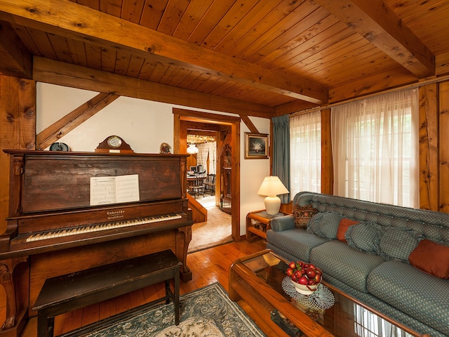 living area featuring wood ceiling, hardwood / wood-style floors, and beamed ceiling