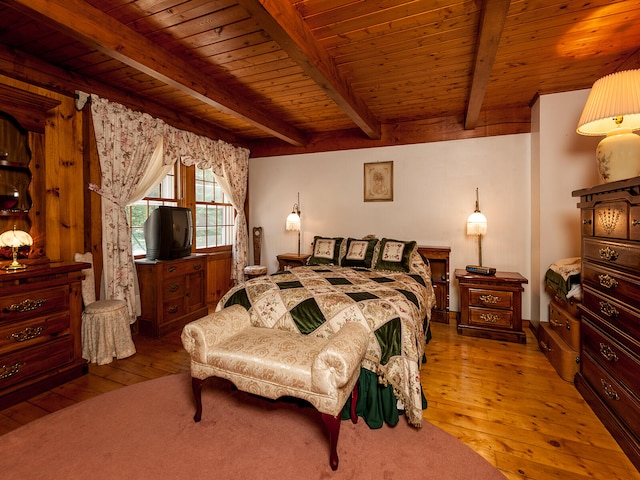 bedroom with wood ceiling, beamed ceiling, and hardwood / wood-style floors
